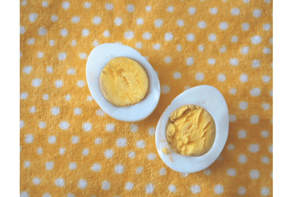 boiled egg cut in half on a polka dotted dish towel