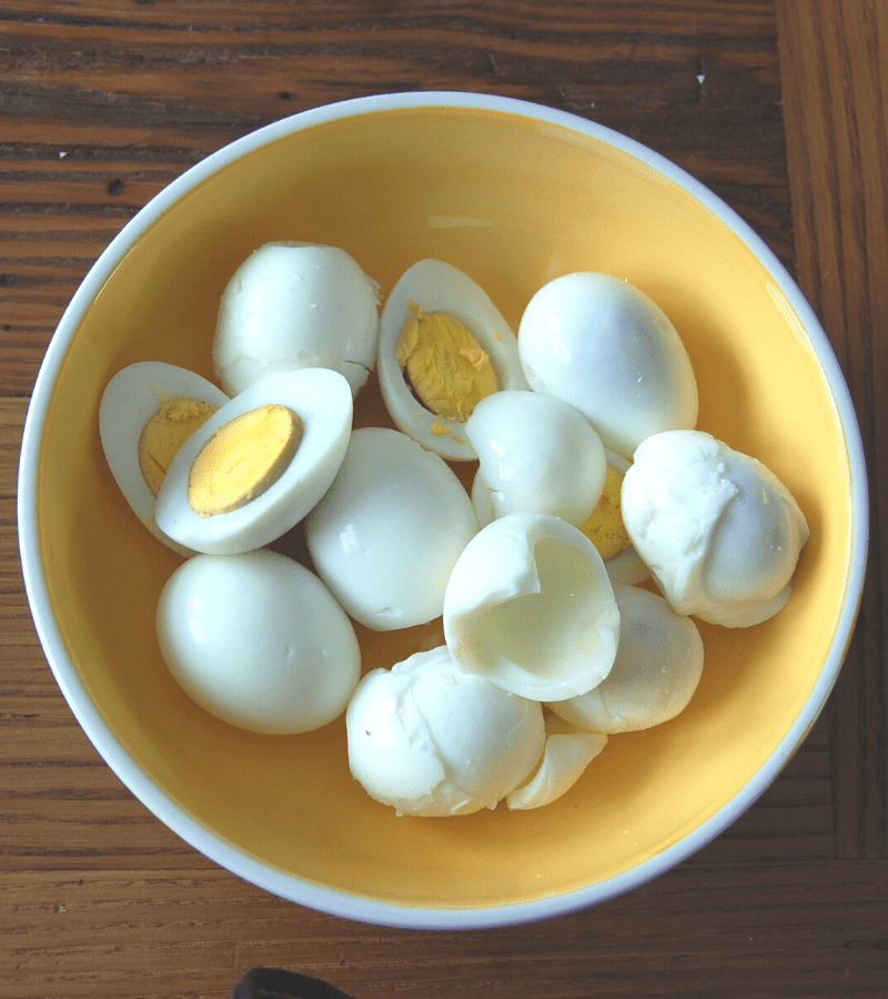 bowl of hard boiled eggs some cut some whole