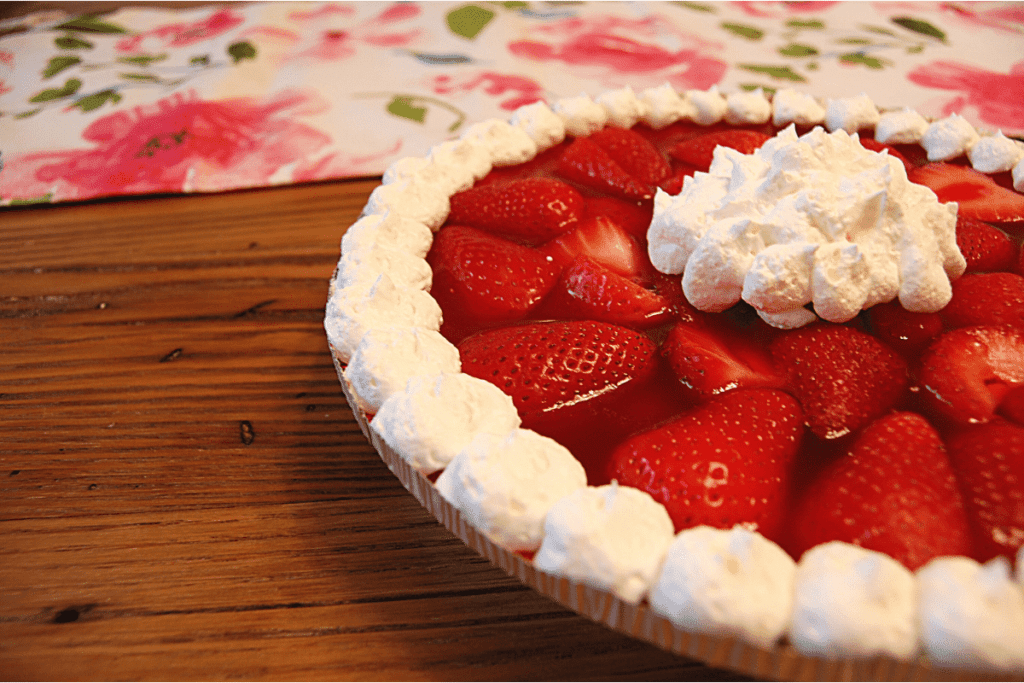 close up of a strawberry pie with cool whip toppoing