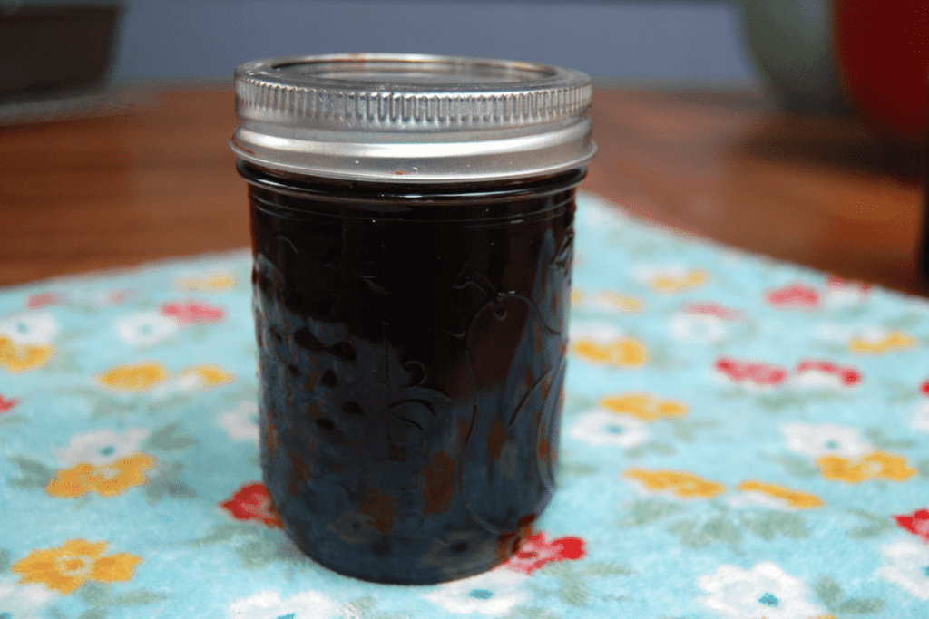 close up of a jar of blackberry jelly
