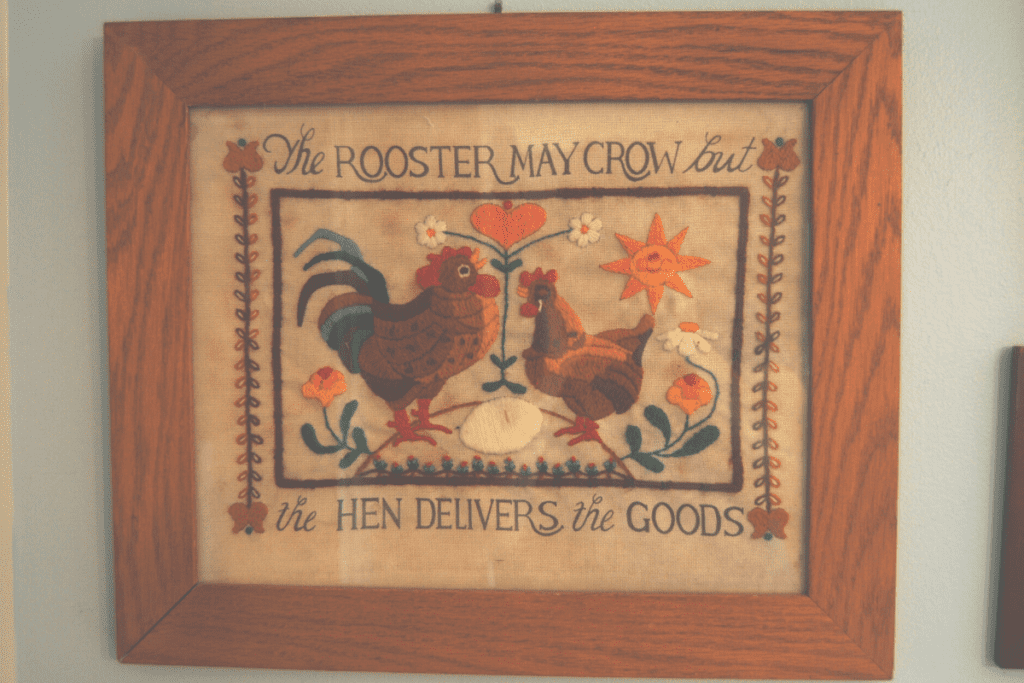 framed embroidery of a hen and a rooster