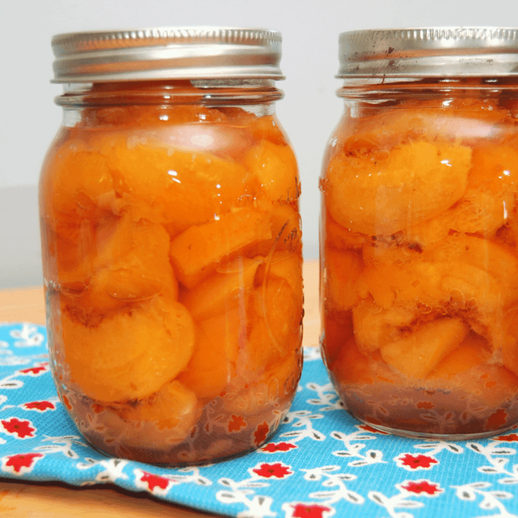 close up of 2 jars of fresh canned peaches